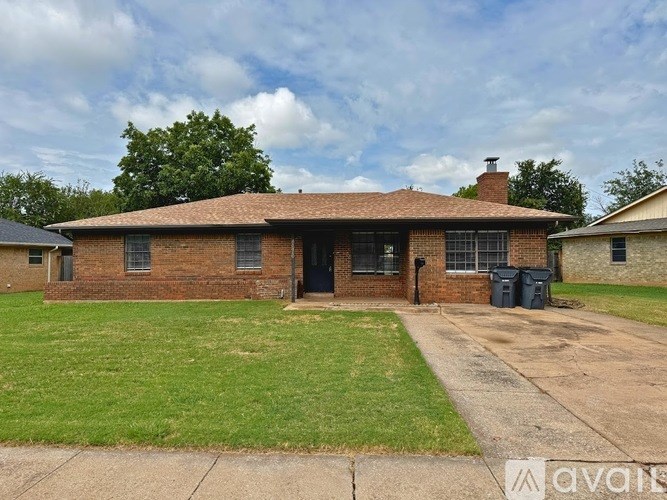 A house with a brick exterior and a black door is for sale.