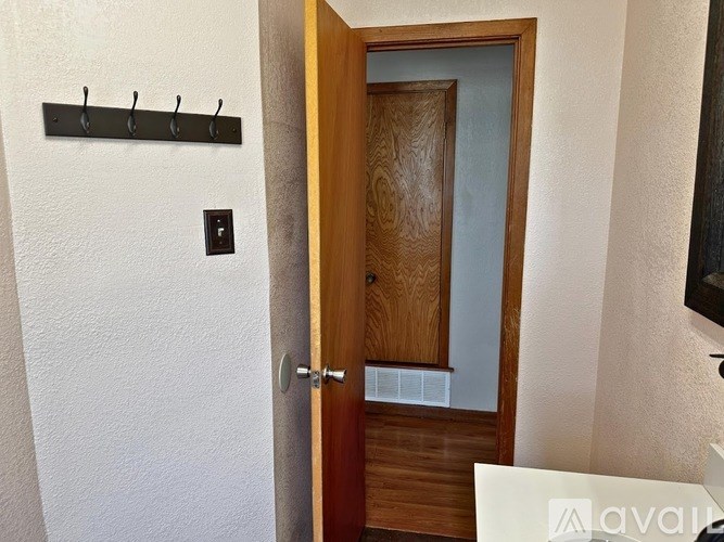 A wooden door with a white chair in front of it.