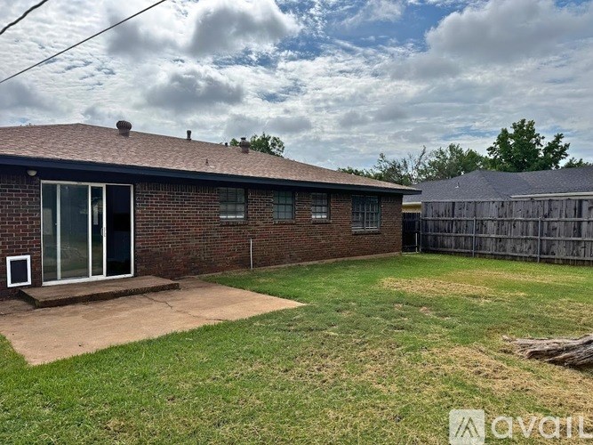 A house with a brown roof and a fence in the backyard.