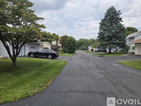 A black car is parked on the side of a street.