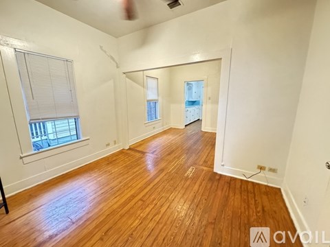 A room with wooden floors and white walls.
