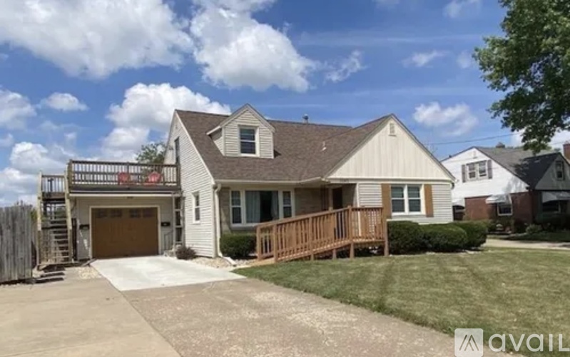 A house with a garage and a deck is for sale.