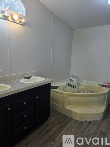 A bathroom with a white sink and a bathtub with a yellow cover.