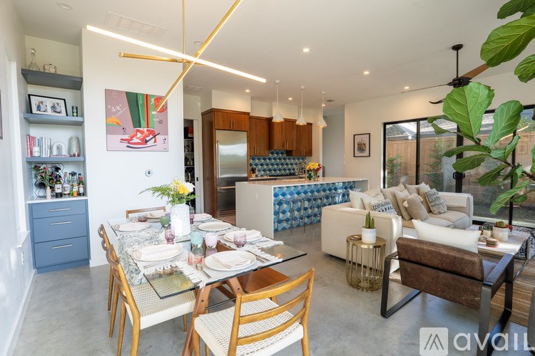 A modern dining room with a glass table set for four.
