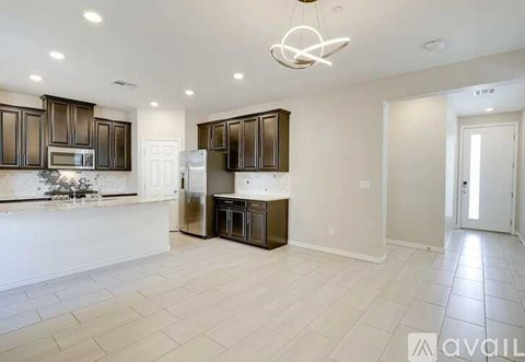 A kitchen with brown cabinets and a white countertop.