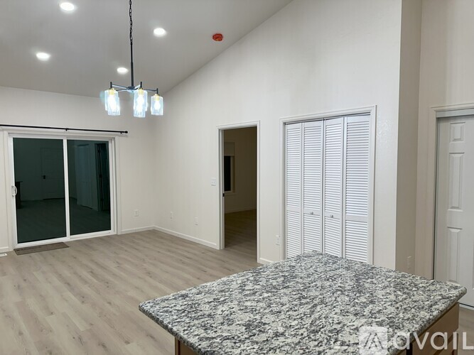 A spacious room with a large window and a view of the outdoors.