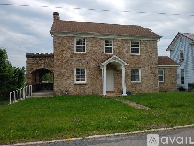A stone house with a white door and windows.