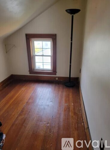A room with wooden floors and a window.