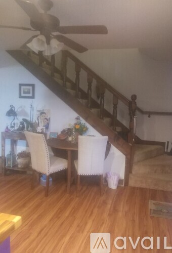 A spacious room with a kitchen area and a sliding glass door leading outside.