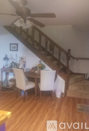 A spacious room with a kitchen area and a sliding glass door leading outside.