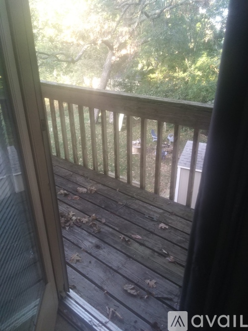 A backyard with a white shed and a table and chairs.