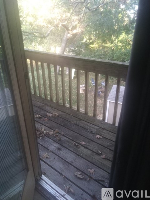 A backyard with a white shed and a table and chairs.