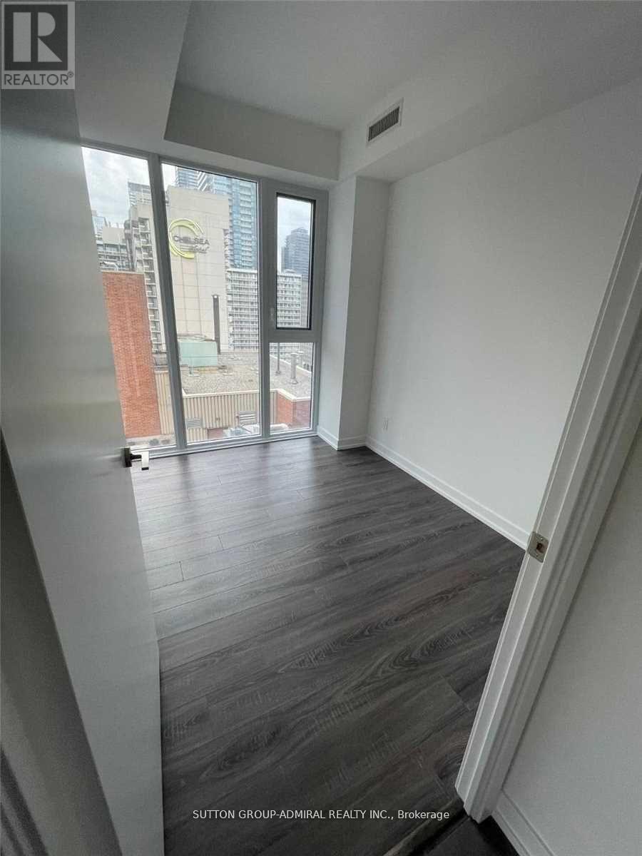 A room with a view of a cityscape through a window.