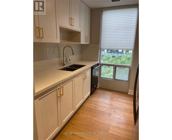 A kitchen with white cabinets and a sink.