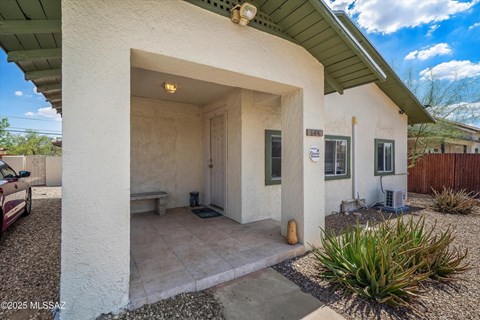 A small house with a covered patio area.
