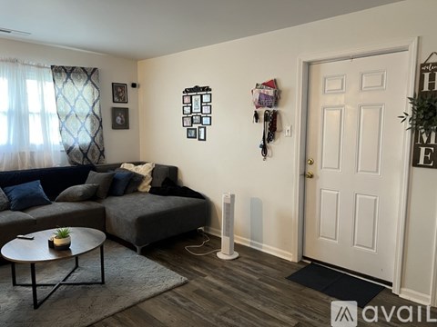 A living room with a grey couch and a coffee table.