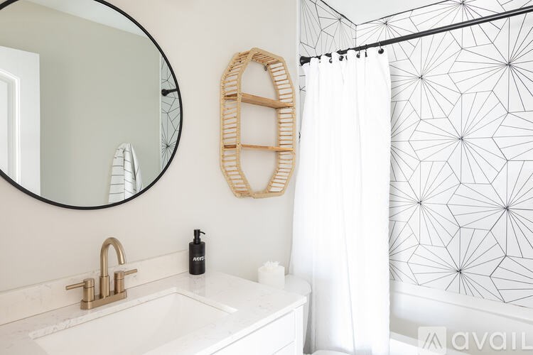 A bathroom with a white sink and a mirror.