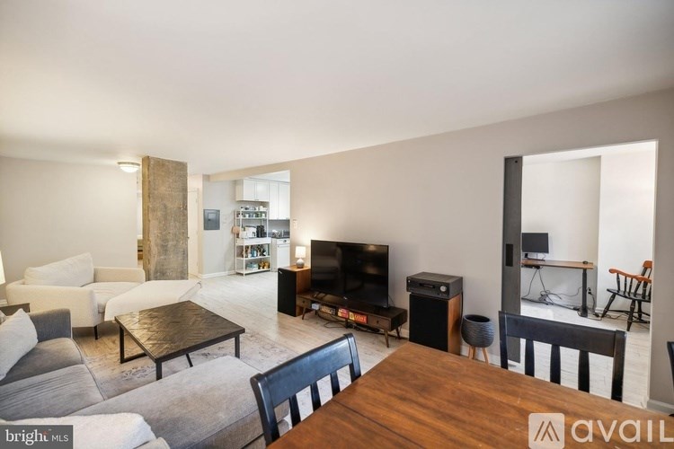 A living room with a wooden table and a television.