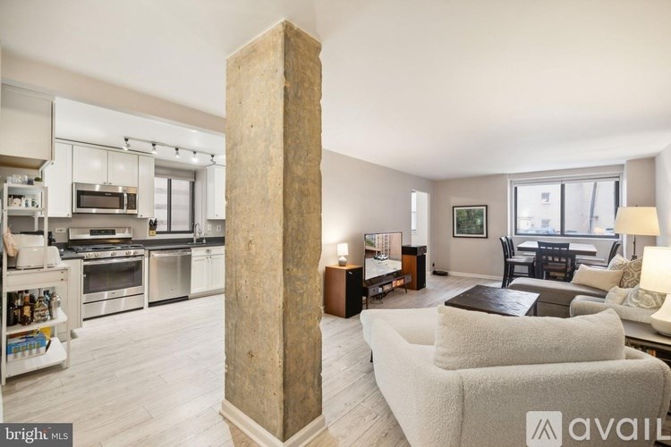 A living room with a tall column in the middle.