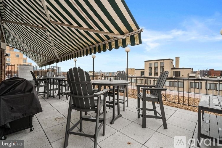 A room with a sliding door, a desk, and a bicycle.