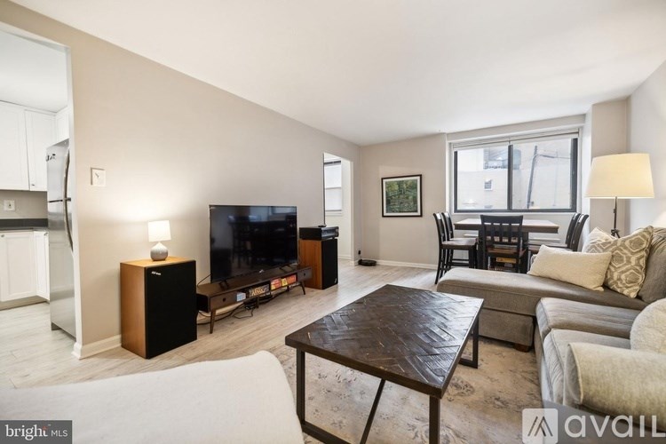 A living room with a television, couch, and coffee table.