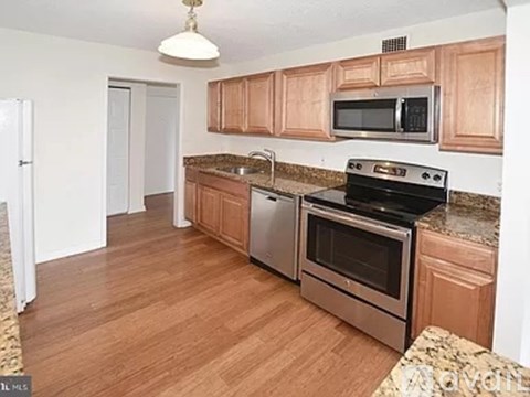 A kitchen with wooden cabinets and stainless steel appliances.