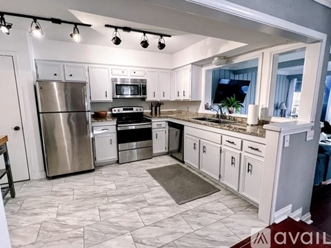A kitchen with a refrigerator, stove, and oven.