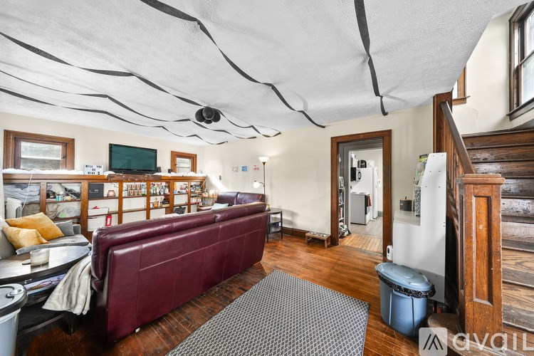 A living room with a red couch and a television.