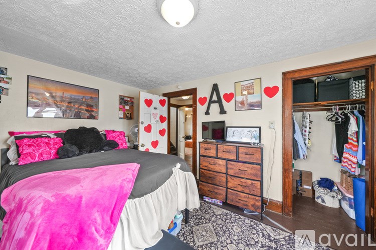 A bedroom with a bed, dresser, and closet.