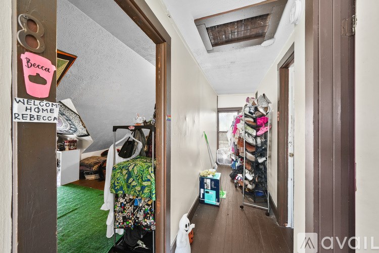 A hallway with a sign that says "Welcome home Rebecca" and a pink heart on it.