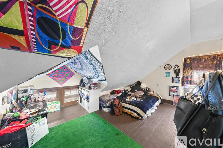 A room with a bed, a chair, and a table with a sign that says "available".