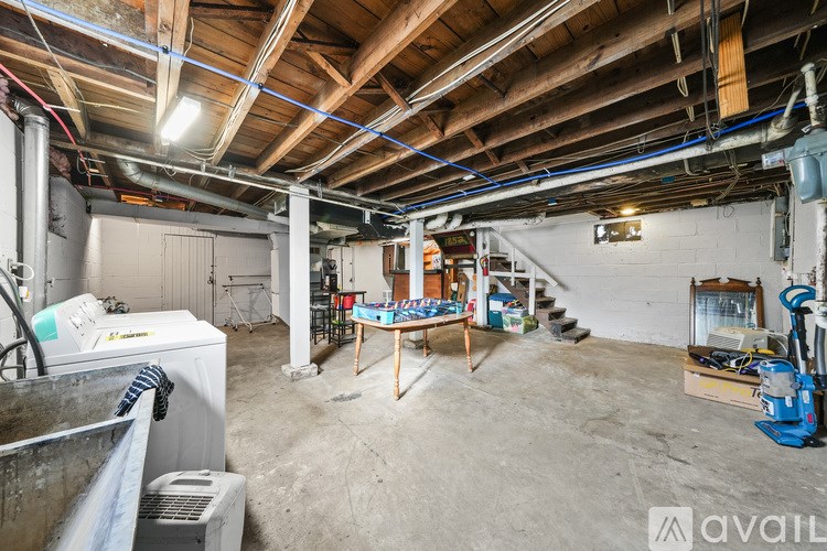 A large, empty room with a concrete floor and a wooden ceiling.