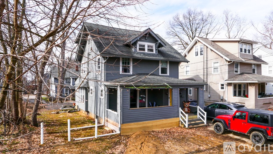 A house with a red truck parked in front.