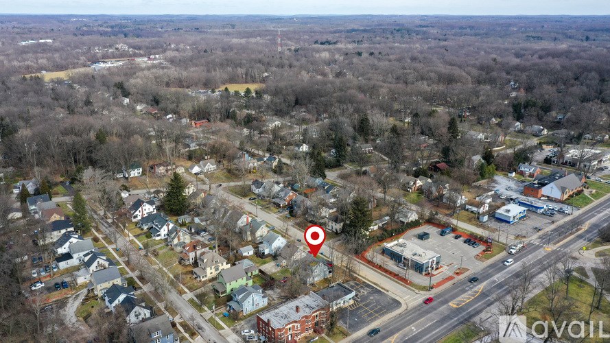 An aerial view of a residential area with a red target symbol indicating a specific location.