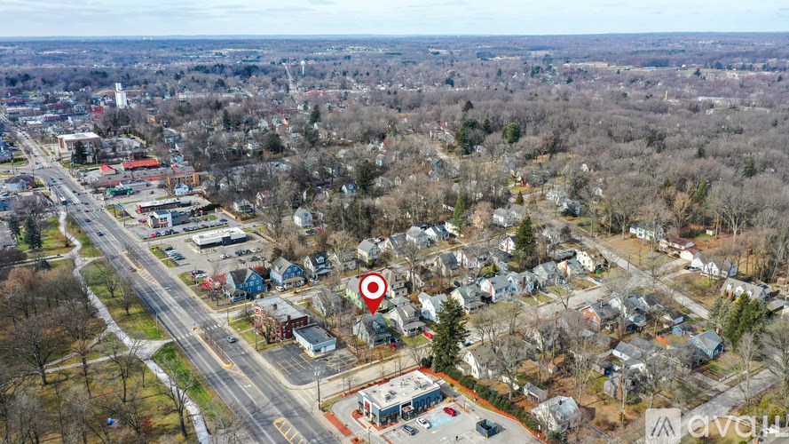An aerial view of a residential area with a red marker indicating a specific location.