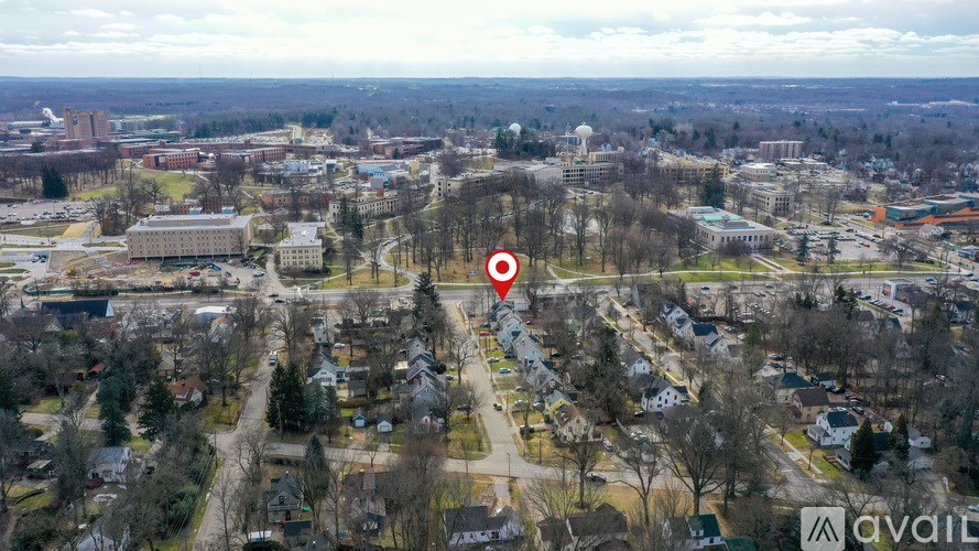 An aerial view of a residential area with a red marker indicating a specific location.