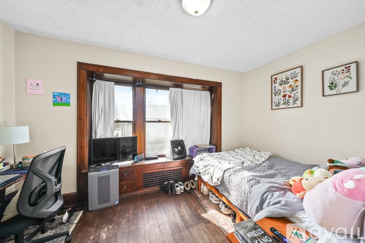 A room with a bed, a desk, and a window.