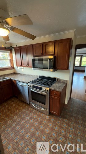A kitchen with a tile floor and a stove top oven.