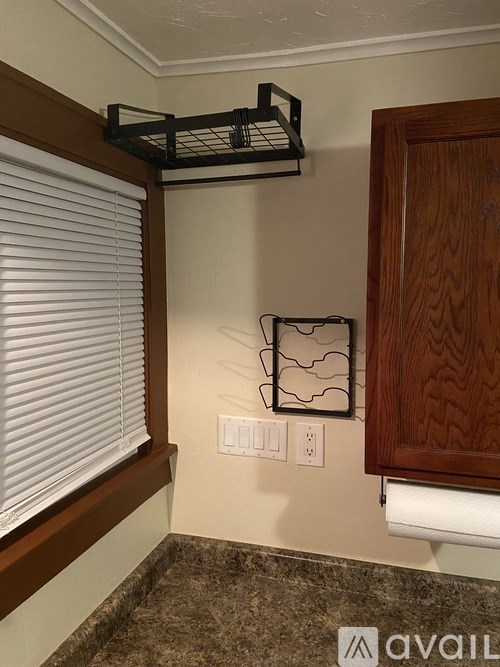 A wall with a shelf and a picture frame on it.