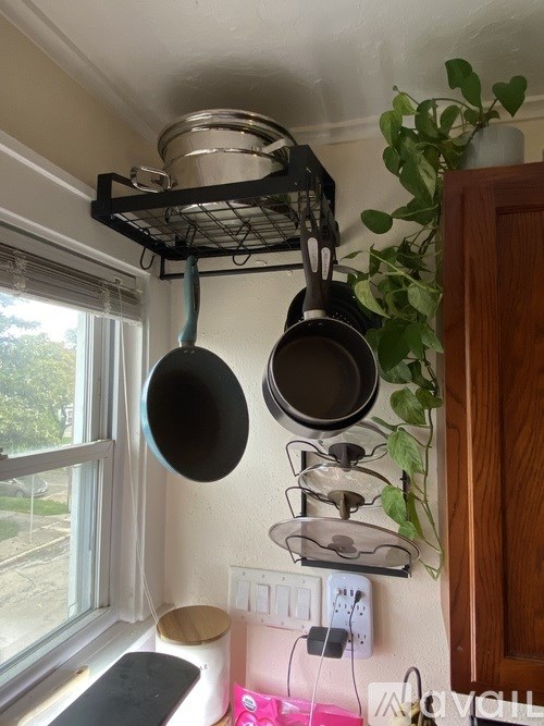 A kitchen with a hanging rack of pots and pans.