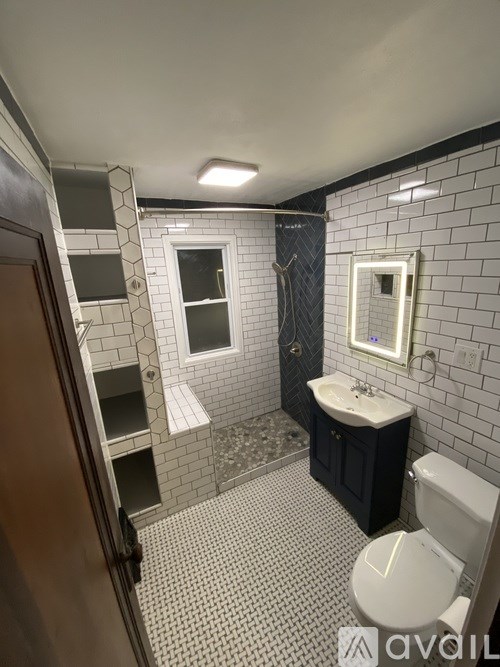 A bathroom with a toilet, sink, and shower.
