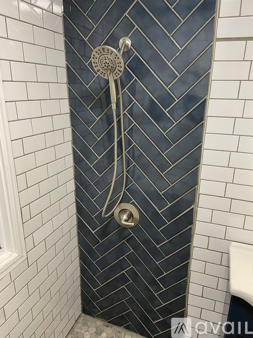 A shower head with a hose attached to it.