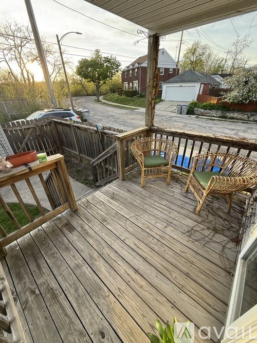A wooden deck with two chairs and a table.