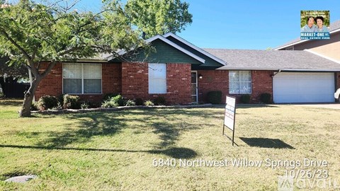 A house with a sign in front of it that says 6840 Northwest Willow Springs Drive 10/26/23.