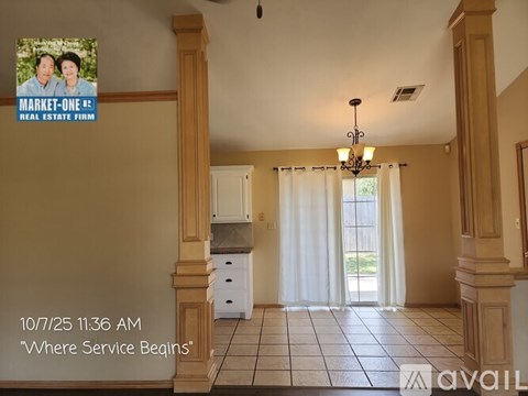 A stainless steel refrigerator in a kitchen with a note attached to it.