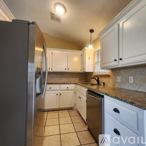 A kitchen sink with a faucet and a window above it.