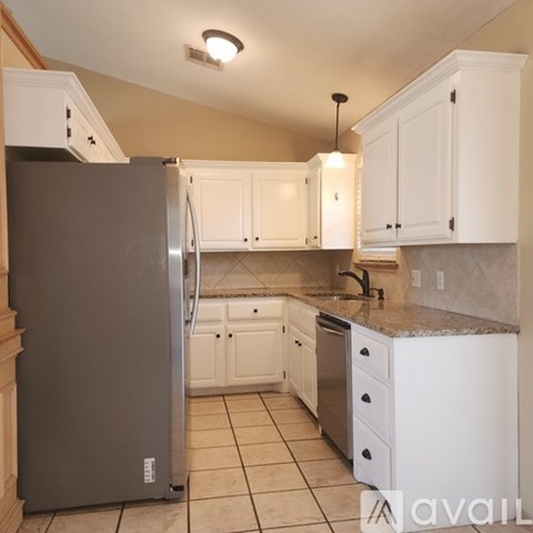 A hallway with a door on the right and a wall-mounted thermostat on the left.