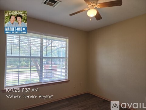 A room with a door and a wall with a poster of two people.