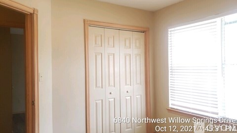 A white door with a label on it that says 6840 Northwest Willow Springs Drive.
