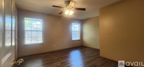 A bathroom with a poster on the wall.